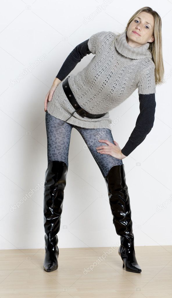 Standing woman wearing fashionable boots
