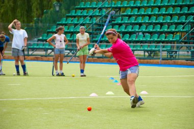 Bandy girl team training on a stadium clipart