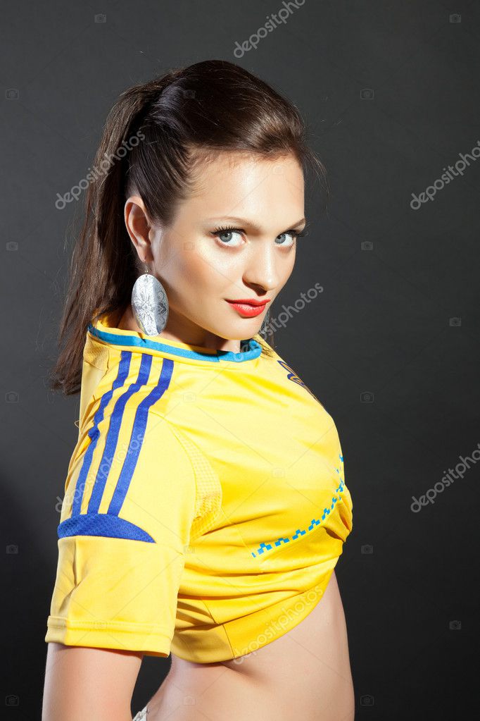 Pretty model posing in Ukraine soccer jersey in studio Stock Photo