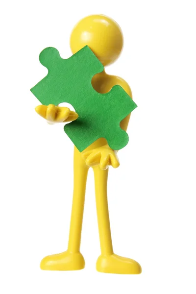Rubber figuur met stuk van puzzel — Stockfoto