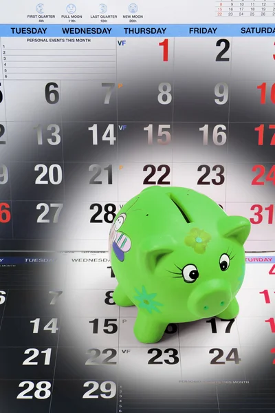 stock image Piggy Bank on Calendar Pages