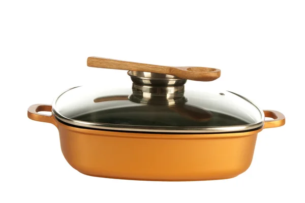 Kookgerei, nonstick pan en houten lepel — Stockfoto