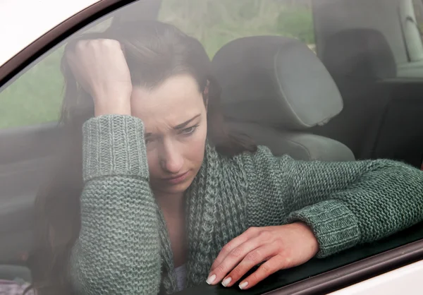 Sad woman in the car — Stock Photo, Image