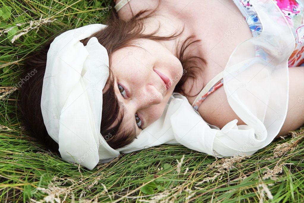 Young Woman Laying on Grass Portrait