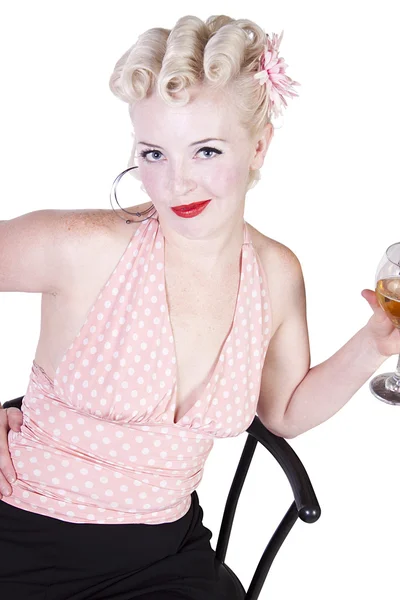 Woman in pin-up dress drinking on a chair - Isolated — Stock Photo, Image