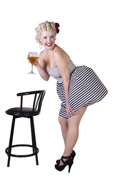 Beautiful pinup retro girl with wine enjoying cool air from fan — Stock Photo, Image