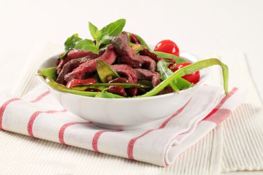 Vegetable salad with strips of beef clipart