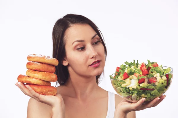 Dilemma: Sweet cakes or healthy salad? — Stock Photo, Image