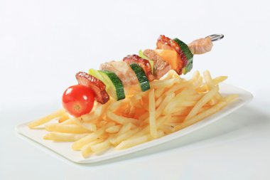 Pork skewer and French fries clipart