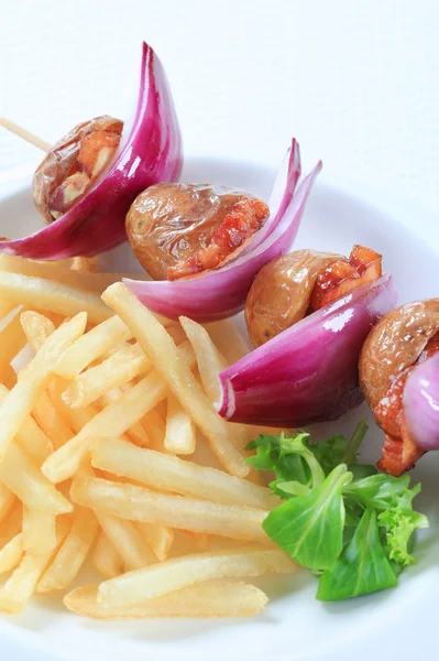 Bacon and potato skewer with fries — Stock Photo, Image