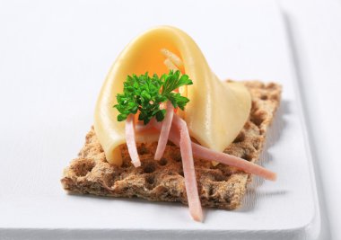 Crispbread with cheese and ham clipart