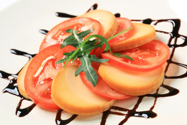 Sliced tomato and smoked cheese — Stock Photo, Image