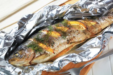 Baked trout with lemon and dill clipart