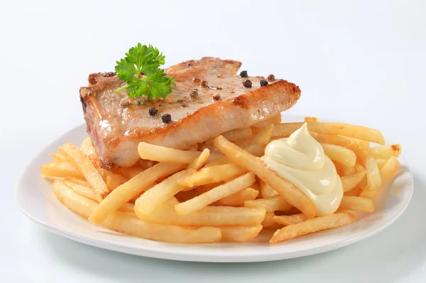 Pan fried pork chop with fries — Stock Photo, Image
