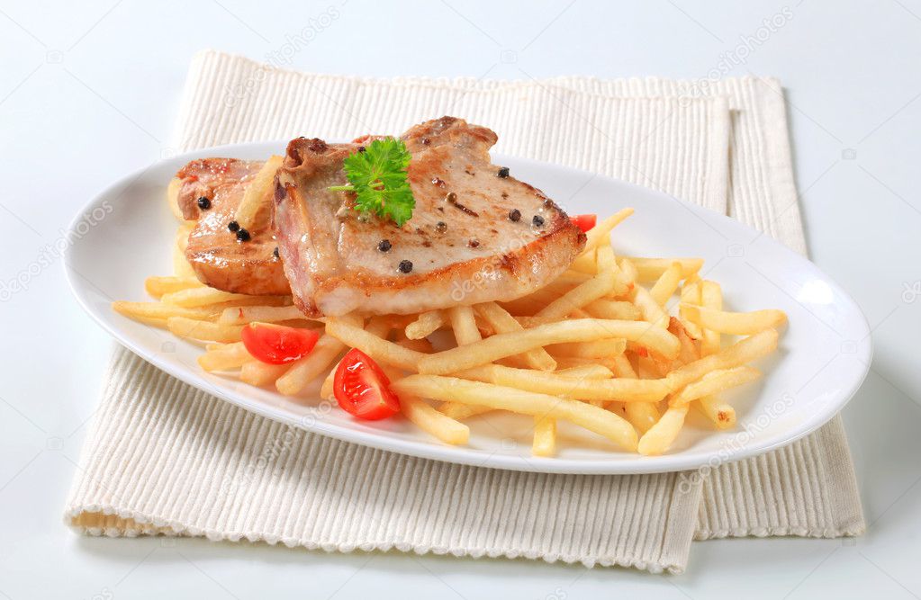 Pan fried pork chops with fries