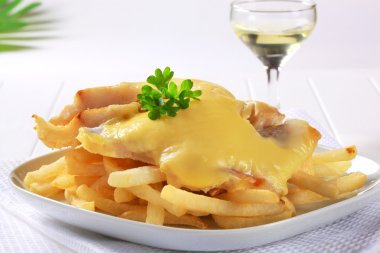 Cheese topped fish fillets with French fries clipart
