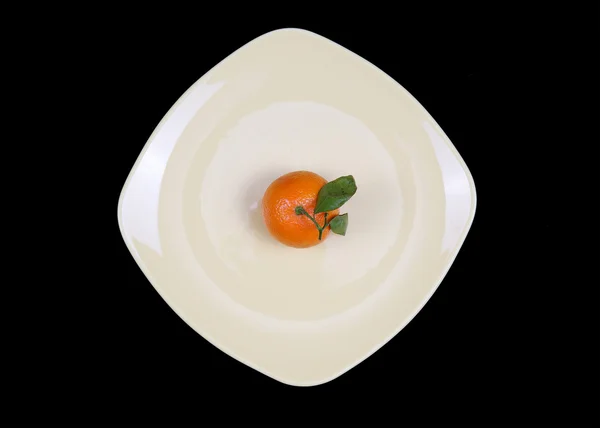 Stock image Tangerines on a plate on a black background