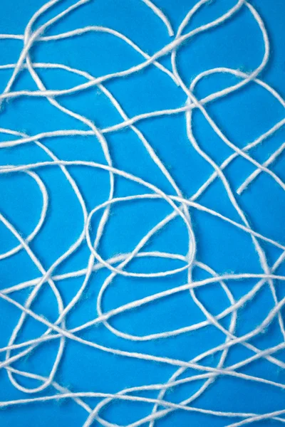 stock image Abstract white wool strings on blue background