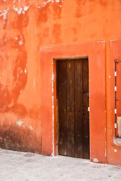 Turuncu adobe ev ahşap kapı ile — Stok fotoğraf