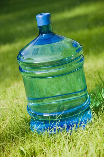 Water big bottle on green grass background — Stock Photo, Image