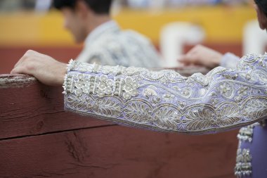 The sleeve of the jacket of a bullfighter.