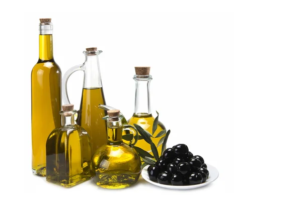 Olívaolaj palackok és fekete olajbogyó. — Stock Fotó