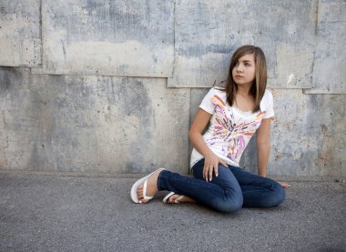 Teen Girl Sitting in Alleyway clipart