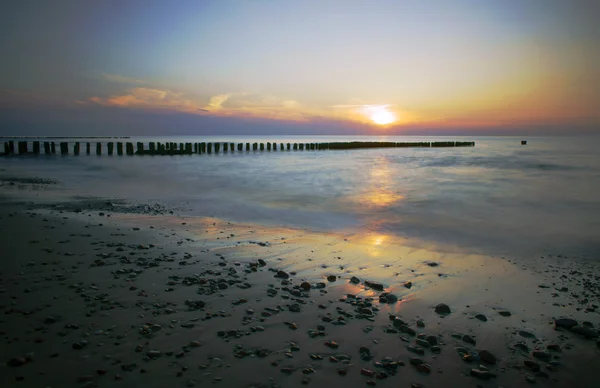 雲と木製の防波堤とビーチ — ストック写真