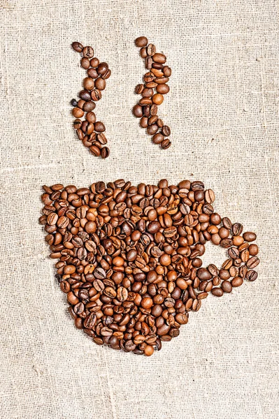 组成的咖啡豆在麻袋上的咖啡杯子图像 — 图库照片