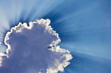 Fantastic sun rays are striking through the clouds clipart