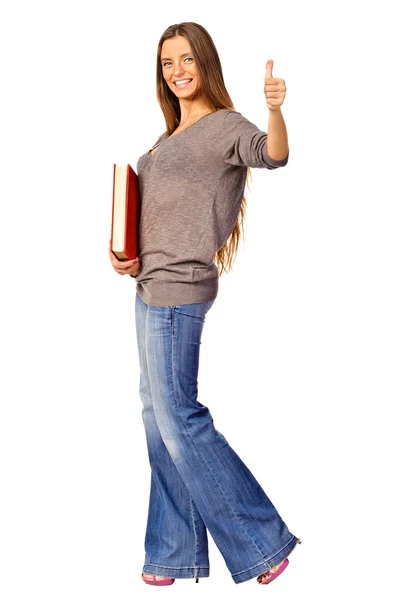Joven estudiante con su libro en la mano haciendo un gesto de pulgar hacia arriba —  Fotos de Stock