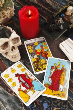 Tarot cards with burning candle clipart