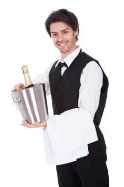 Portrait of a butler with bottle of champagne clipart