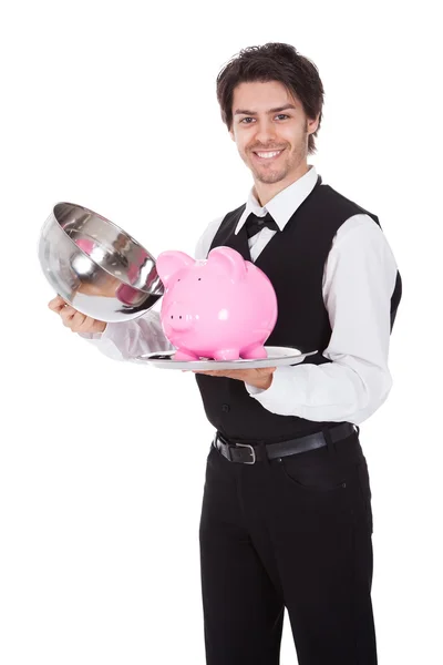 Portrait of a butler with piggybank — Stock Photo, Image