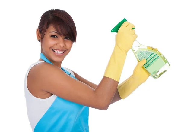 Cheerful young lady spraying cleaner liquid — Stock Photo, Image