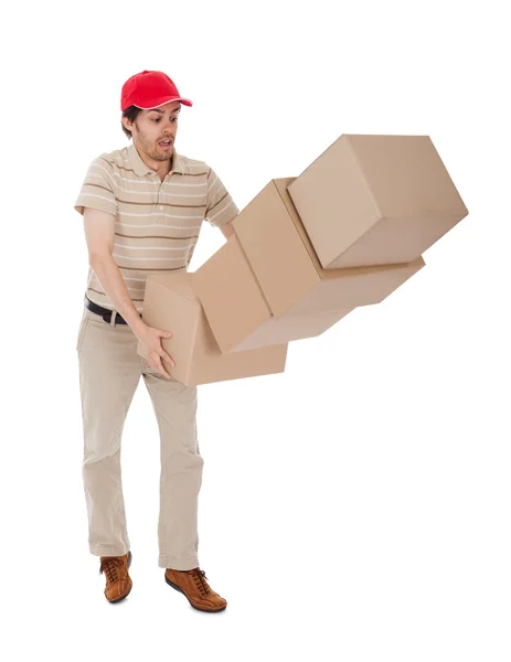 Człowiek dostawy z objętych stosu pudeł — Zdjęcie stockowe