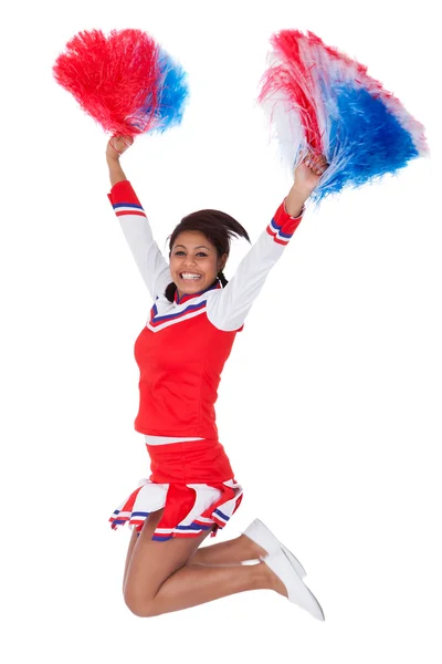 Sorridente bella cheerleader con pompon — Foto Stock