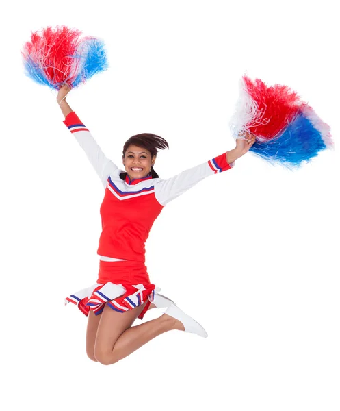 Lächelnde schöne Cheerleader mit Bommeln — Stockfoto