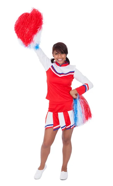 Sorridente bella cheerleader con pompon — Foto Stock