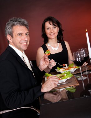 Couple at romantic dinner in restaurant clipart