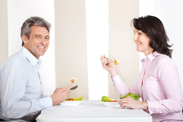 Mature couple having lunch at home — Stock Photo, Image