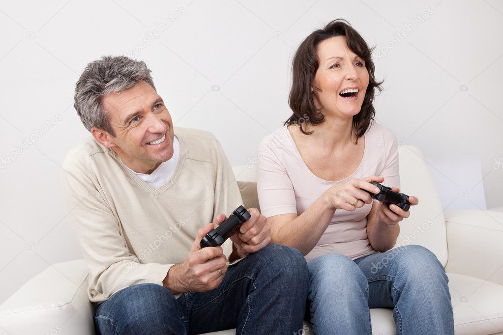 Mature couple enjoying videogames