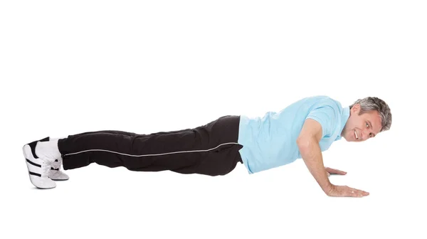 Active mature man doing pushups — Stock Photo, Image