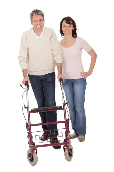 Mature couple using walking aide — Stock Photo, Image
