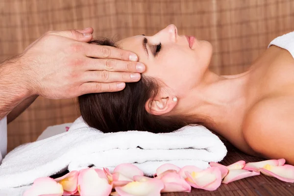 Beautiful young woman getting face massage — Stock Photo, Image