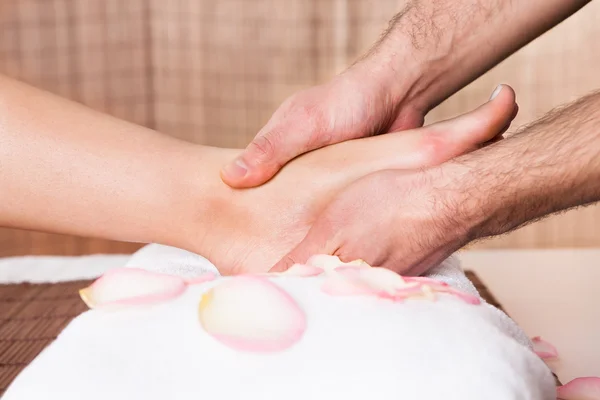 Beautiful young woman getting feet massage — Stock Photo, Image