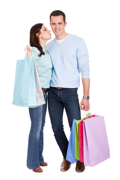 Schönes junges Paar mit Einkaufstaschen — Stockfoto