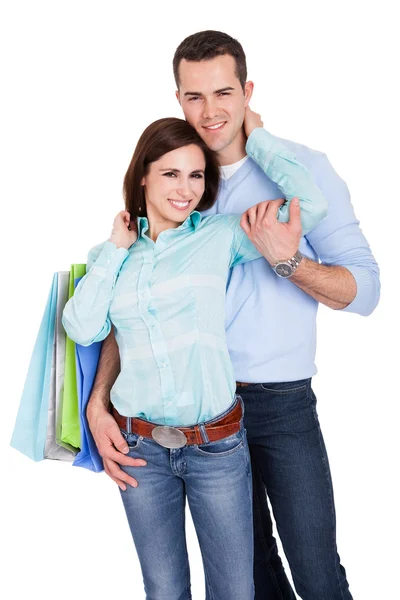 Krásný mladý pár s nákupní tašky — Stock fotografie