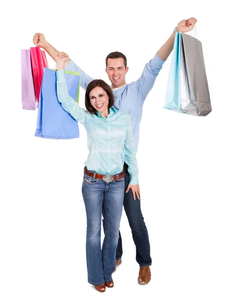 Hermosa pareja joven con bolsas de compras —  Fotos de Stock