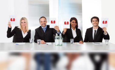 Panel judges holding perfect score signs clipart